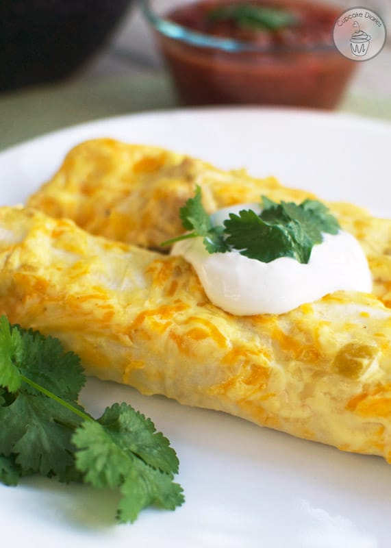 Chicken Enchiladas - Cheesy enchiladas filled with tender chicken and a creamy sauce. These are a family favorite!
