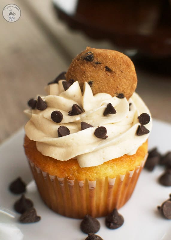 Chocolate Chip Cookie Dough Cupcakes - A delicious vanilla cupcake topped with chocolate chip cookie dough frosting with a cookie dough surprise in the center. These are one of my favorite cupcakes I've ever made!