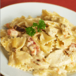 Copycat Johnny Carino's Bowtie Festival features a decadent cream sauce, grilled chicken, and smoked bacon. It's no wonder it's a restaurant favorite!