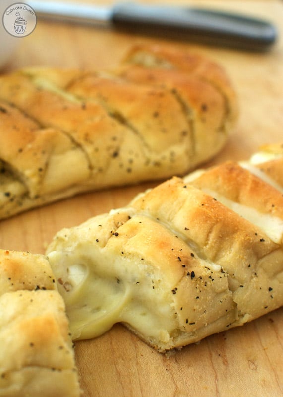 Baked Rhodes Bake 'n Serv bread topped with garlic butter and stuffed with gooey cheese.