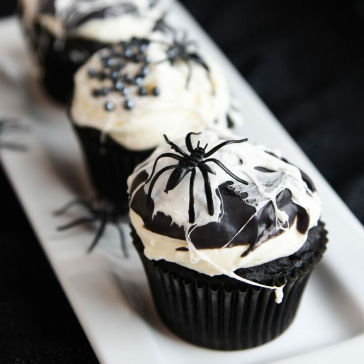 Black and White Spider Web Cupcakes are so fun to make and they're so creepy for a Halloween party! Dark chocolate cake combines with marshmallow buttercream for these spooky treats.