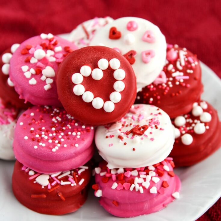 Homemade Dipped Oreos for Valentine's Day are so bright, fun, and easy to make! Package them up in cellophane bags for a simple and tasty valentine gift.